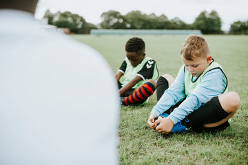 Young football kids stretching on the field