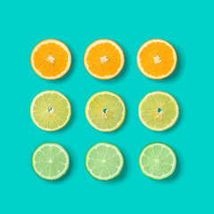Citrus Fruit pattern on blue background. Orange, Lime, Lemon slices background. Flat lay, top view.