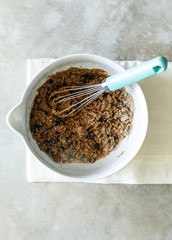 Chocolate chip cookie dough in a bowl with whisk