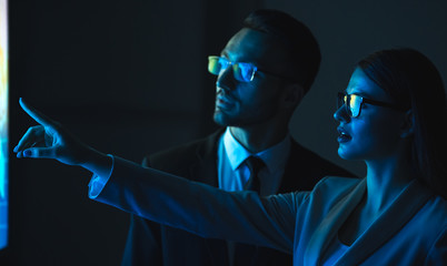 The business couple gesturing in the blue room