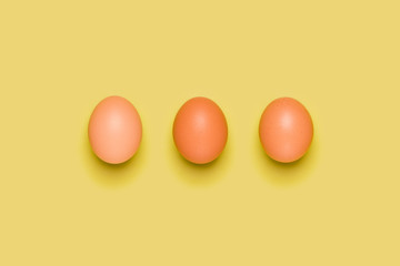 Eggs pattern on yellow background. Easter concept. Flat lay, top view. Food background.