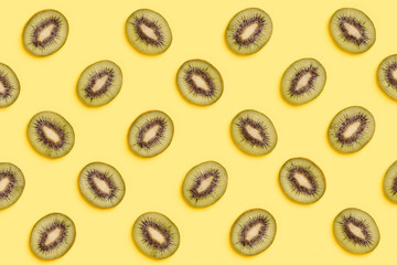 Kiwi slices pattern on green background. Food background. Fruit pattern.  Pop art design, creative summer concept.