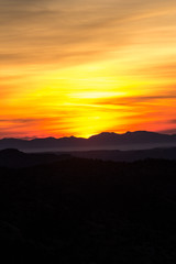 Sunrise silhouettes the mountains.  