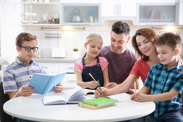 Children with parents doing homework at home