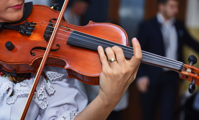 Close view of girls hand on violins strings