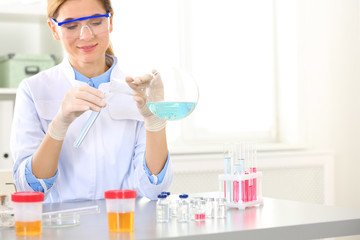 Female scientist working at table in laboratory, space for text. Research and analysis