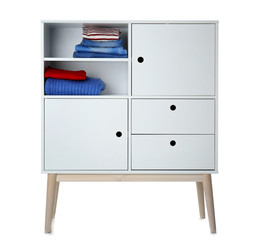Stylish dresser with clothes on white background. Furniture for wardrobe room