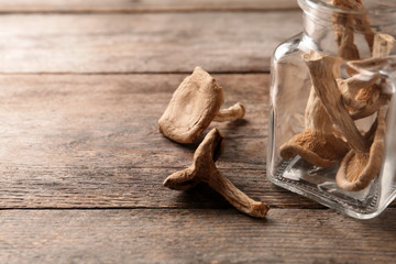 Composition of dried mushrooms and glassware on table, closeup. Space for text