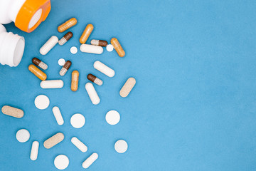 Medical Or Pharmaceutical Preparations: Assorted Colorful Tablets, Pills, Medicines And Capsules On Pale Pastel Blue Background, Top View. Copy Space On Medical Topics.