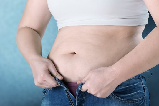 Woman with belly fat getting dressed