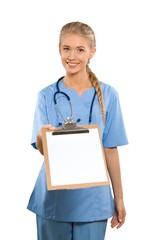 Beautiful young female nurse handing over clipboard