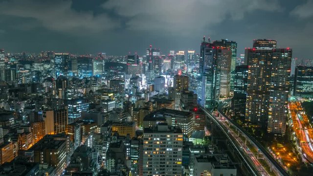 Timelapse Overview of Congested Tokyo Cityscape at Night -Tilt Down-
