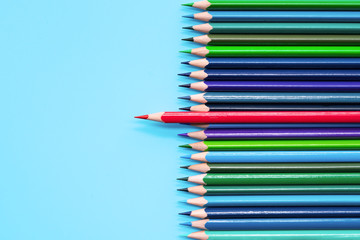 Red pencil standing out on blue background. Leadership, uniqueness, independence, initiative, strategy, dissent, think different, business concept