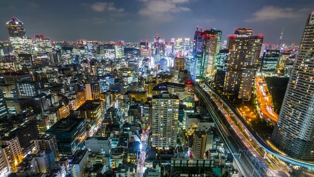 Timelapse Overview of Congested Tokyo Cityscape at Night -Tilt Down-