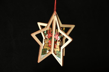 Christmas decoration, wooden star on black background