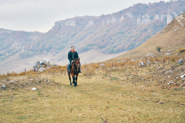 Fototapeta na wymiar man riding a horse nature