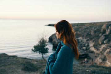 Fototapeta na wymiar woman in a blanket on the sea