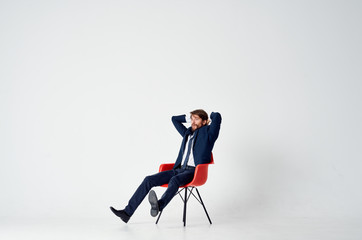 business man sitting in a red chair