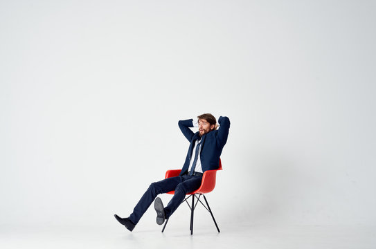 Business Man Sitting In A Red Chair