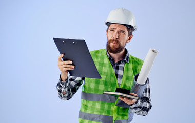 builder in helmet with drawings architecture