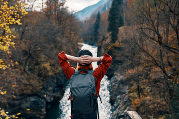 woman on nature in the forest autumn river