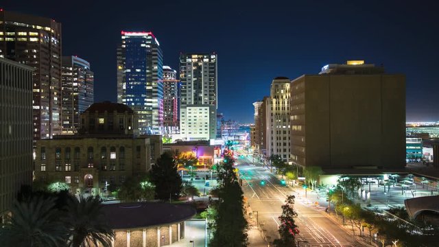 Generic Phoenix Arizona Downtown City Scene Vibrant Timelapse in a Colorful Night Setting with Streaking Lights from Driving Cars Between Building Architecture Exteriors