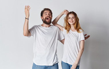 young cheerful couple in white t-shirts