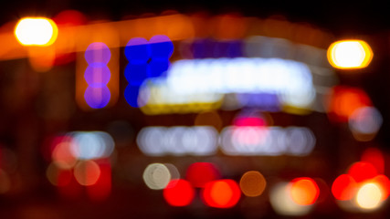 Urban night illumination background with artificially blurred neon and led lighting of buildings...
