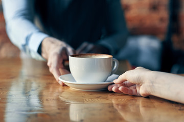 Fototapeta na wymiar hands holding cup of coffee