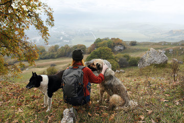 woman in the mountains with dogs autumn