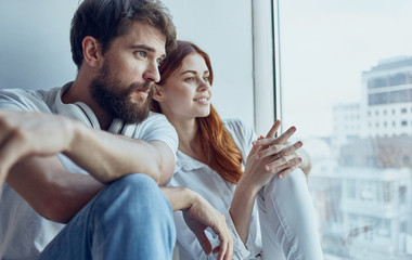young couple communicates look out the window