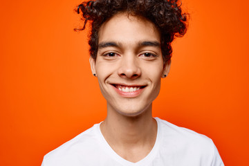 african man smiling on orange background