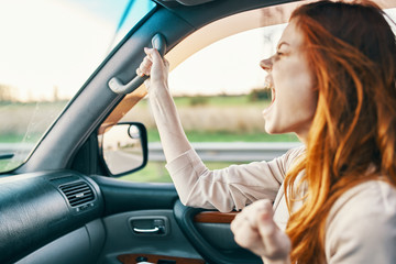 Fototapeta na wymiar woman riding in car screaming