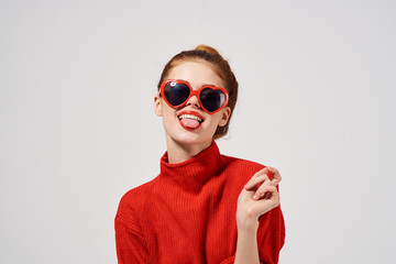 young woman in glasses shows tongue portrait