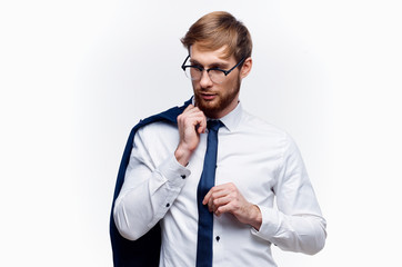 business man in glasses holding a jacket