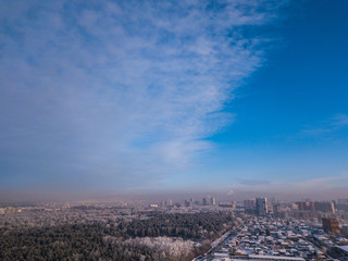 Urban landscape: high modern residential buildings, streets, shopping centers,  sky and clouds in a cold winter day shooting with quadrocopter