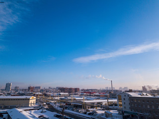 Urban landscape: high modern residential buildings, streets, shopping centers,  sky and clouds in a cold winter day shooting with quadrocopter