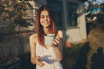 woman in the country with a mug