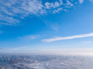 Obraz premium Urban landscape: high modern residential buildings, streets, shopping centers, sky and clouds in a cold winter day shooting with quadrocopter