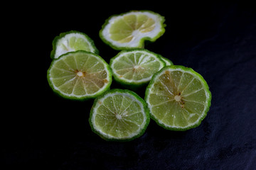 Fototapeta na wymiar Bergamot or Kaffir lime Cut half isolate on black background 
