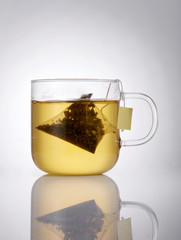 Closeup soaked tea bag of tea on a white background