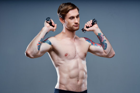 muscular body man with dumbbells