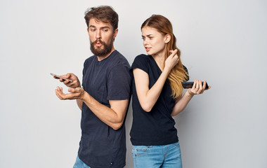 young couple in black t-shirts smartphones logo style