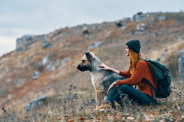woman with a dog in nature