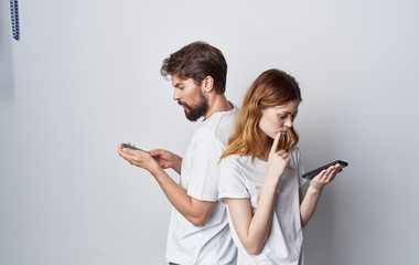 young couple with smartphones