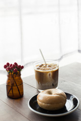 Fresh Bagel with coffee over wooden table. 