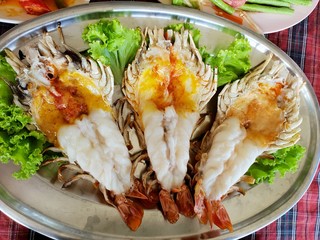 Top view of barbecued shrimp on tray in restaurant, Grilled giant river prawn as a background ( Macrobrachium rosenbergii)