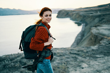 woman hiking with backpack sea