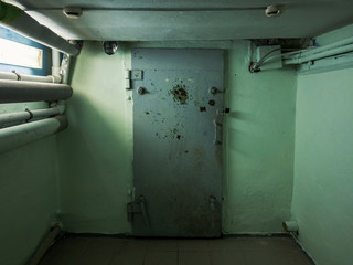 Closed metal door in dark basement