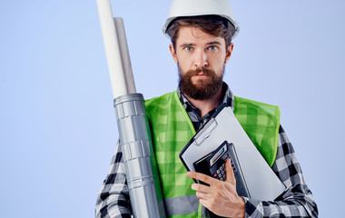 male builder in a helmet with documents